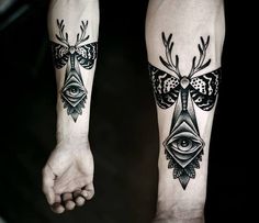 two people with tattoos on their arms and one has an all seeing eye tattoo on his arm