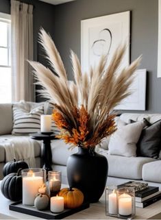 a living room filled with lots of furniture and candles on top of a coffee table