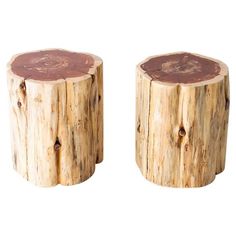 two wooden stools made out of logs on a white background, one is brown and the other is red