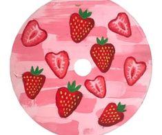 a painted wooden plate with strawberries on it