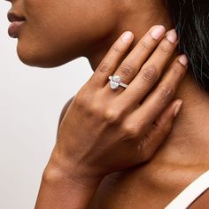 a woman wearing a diamond ring on her neck