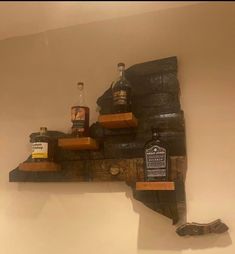 a wooden shelf with liquor bottles on it and an empty bottle sitting on top of the shelf