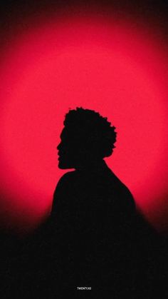 the silhouette of a person against a red background