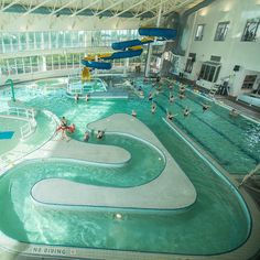 an indoor swimming pool with people in it