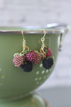 small beaded fruit earrings on a green bowl