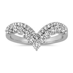 a white gold ring with diamonds on the sides and an arrow shaped design in the middle