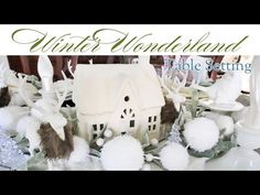 winter wonderland table setting with white and silver decorations, bird houses, snowflakes