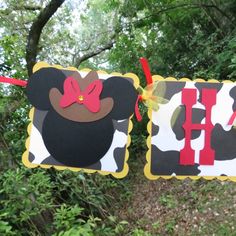 mickey and minnie mouse birthday banner hanging from trees