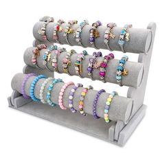 a display rack with bracelets and rings on the top of each one in different colors