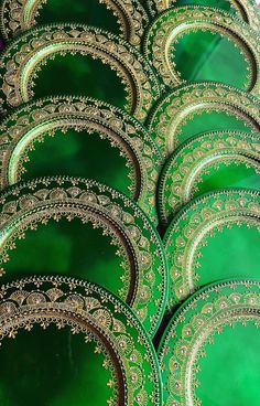 many green plates with gold designs on them