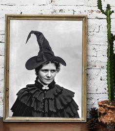 a black and white photo of a man wearing a witches hat