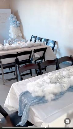 the tables are set up with white and blue decorations