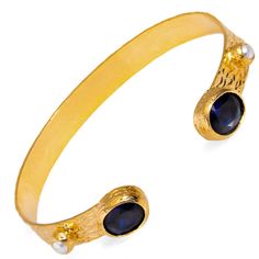 Experience timeless elegance with the Cleopatra Sapphire & Pearl Adjustable Gold Cuff Bracelet. This stunning cuff bracelet, plated in 24k gold on brass, showcases beautiful sapphire stones that come together in perfect harmony. Small pearl accents adorn the bracelet, adding a touch of sophistication and enhancing its authentic, regal charm. Designed to bring both style and elegance to any look, this adjustable cuff bracelet is the perfect statement piece. Details Sapphire stone Crafted with high-quality brass and plated with 24k gold for a luxurious finish. Adjustable size Avoid contact with chemicals, makeup, parfume. Do not use dips or abrasive cleaners on bracelet. To clean and brighten it up your bracelet, wipe them gently with jewelry polishing cloth. Elegant Adjustable Blue Cuff Bracelet, Elegant Blue Bangle For Formal Occasions, Gold Cuff Bracelet, Sapphire Stones, Forever Jewelry, Gold Bracelet Cuff, Gold Cuffs, Perfect Harmony, Sapphire Stone