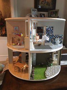 a doll house with furniture and accessories inside