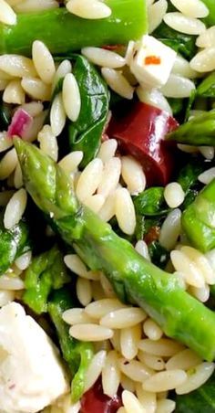 a salad with asparagus, chicken and white beans is shown in close up