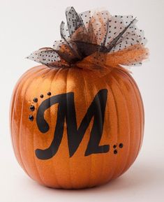 a decorated pumpkin with the letter m on it