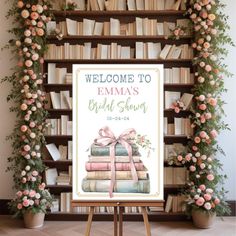 a welcome sign is displayed in front of a bookshelf with flowers and greenery