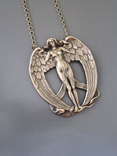 "Vintage Jewelry - Vintage Necklace - Art Nouveau Necklace - Angel Necklace - Brass Necklace - Statement Necklace - Chloe's Vintage Jewelry This is such a fabulous vintage Art Nouveau necklace! A large brass angel stamping with incredible detail. So very  feminine.  The pendant hangs from a vintage brass ladder chain. Chloe says, \"Wear it and feel fabulous!\" This pendant is 2 1/2\" tall.  You can choose the necklace length you would like at checkout. Thanks for visiting Chloe's" Artistic Bronze Jewelry For Gifts, Artistic Bronze Jewelry For Gift, Artistic Bronze Jewelry Gift, Art Nouveau Silver Brass Jewelry, Artistic Engraved Bronze Jewelry, Art Deco Engraved Necklace As Gift, Art Nouveau Brass Pendant Necklace, Art Deco Necklace With Large Pendant, Handmade Art Nouveau Jewelry