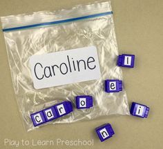 a bag filled with blue and white letters sitting on top of a table next to each other