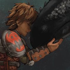 a young boy is holding a large black dragon