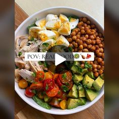 a white bowl filled with lots of food on top of a wooden table and the words pov real food above it