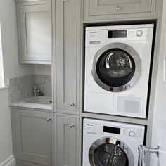 a washer and dryer are stacked on top of each other in a laundry room