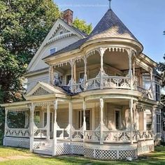 an old victorian style house with white trim