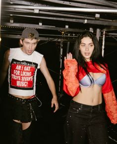 two young people dressed in costumes and posing for the camera with one holding up her hand