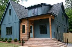 a blue house with steps leading up to the front door