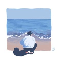 a man sitting on top of a beach next to the ocean