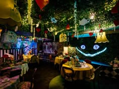 a room filled with lots of tables covered in decorations and hanging from the ceiling above them