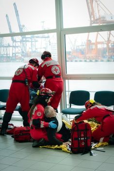 some people in red and white uniforms are on the ground