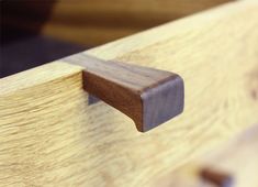 a close up of a wooden drawer handle