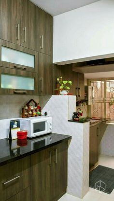 a kitchen with wooden cabinets and black counter tops