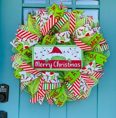 a merry christmas wreath on the front door