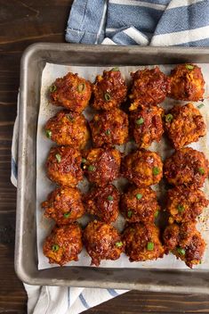 meatballs on a baking sheet ready to be cooked in the oven and served with rice