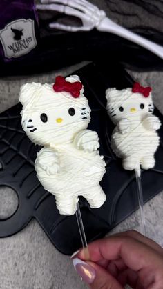 two hello kitty cupcakes with white frosting