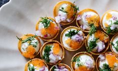 small appetizers are arranged on a white plate