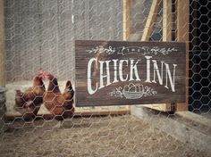 a chicken in a pen with a sign that says, chick inn on it's side