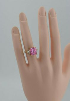 10K Yellow Gold Pink and white Cubic Zirconia Fashion ring, 15 ct plus emerald cut center with pink trillion sides in white modern, Ring size 6, 5.6 grams Stock # BB131R07 Most rings are sizable for a small fee. If the ring you are considering is the incorrect size contact us for a quote. This listing contains photographs of the actual item you will receive. Our items are in excellent condition with little or no signs of wear and many are one of a kind pre-owned estate finds. Please look closely Modern Ring, Fashion Ring, Emerald Cut, Pink And White, Fashion Rings, Heart Ring, Cubic Zirconia, Emerald, Ring Size