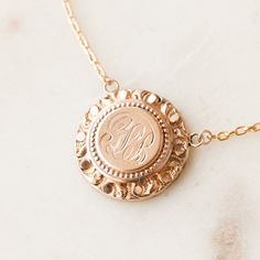 This one-of-a-kind necklace is composed of: Victorian medallion from the late 1800s with the initials "GLB" hand-engraved in the center. This necklace measures a standard 18” on a modern 14k gold filled chain, with the pendant measuring 0.875" in height. Elegant Etched Round Disc Necklace, Medallion Etched Necklace For Anniversary, Etched Medallion Necklace For Anniversary, Engraved Medallion Necklace With Initial Pendant For Gifts, Engraved Initial Pendant Medallion Necklace As A Gift, Engraved Initial Pendant Medallion Necklace, Engraved Initial Pendant Medallion Necklace For Gift, Engraved Round Medallion Necklace For Anniversary, Engraved Medallion Necklace For Anniversary