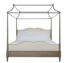 two metal beds with white sheets and pillows, one is made in the style of a four poster bed