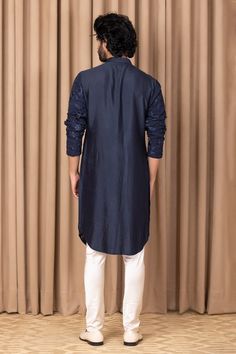 Navy blue straight kurta with floral thread embroidery on the front and sleeves. Comes with an ivory churidar.
Component: 2
Pattern: Embroidered
Type Of Work: Thread Work
Neckline: Mandarin Collar
Sleeve Type: Straight Long
Fabric: Pure Georgette, Lining: Cotton
Color: Blue
Other Details: 
Front button down
Attached lining
Sequin highlights
Note: Pant worn by the model is not for sale
Occasion: Wedding - Aza Fashions Formal Unstitched Kurta With Embroidered Sleeves, Semi-stitched Kurta With Embroidered Sleeves, Designer Blue Kurta With Embroidered Sleeves, Blue Straight Kurta With Embroidered Sleeves, Traditional Blue Kurta With Embroidered Sleeves, Eid Kurta With Embroidered Sleeves And Traditional Drape, Traditional Drape Kurta With Embroidered Sleeves, Blue Long Sleeve Sherwani With Floral Embroidery, Indigo Kurta With Floral Embroidery For Eid