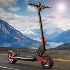 an electric scooter on the road with mountains in the background