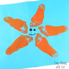 an orange handprinted flower on a blue background