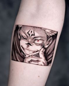 a person with a tattoo on their arm that has an image of a demon in it