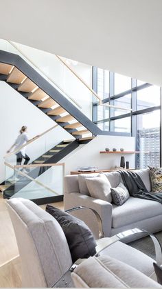 a living room filled with furniture and a stair case