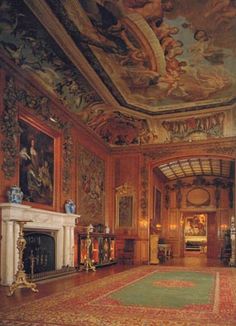 an ornate room with paintings on the ceiling and carpeted floor, along with fireplace