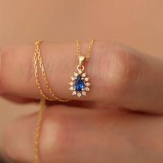 Dazzle her with this stunning Real Diamond Sapphire Drop Necklace, intricately set in luxurious 14K Solid Gold. A timeless beauty and September's birthstone, this pendant is the perfect token of love for Mother's Day, your girlfriend, or wife. Authentic elegance, forever cherished. Sapphire symbolizes loyalty, love and longing. It gives positive vitality with the wonderful energy given by its color. Our 14K Solid Gold Drop sapphire necklace surrounded by diamonds is suitable for daily use. A sty Pear-shaped Diamond Birthstone Jewelry, Pear-shaped Cubic Zirconia Birthstone Jewelry, Sapphire Necklace With Prong Setting For Wedding, Yellow Gold Sapphire Necklaces For Wedding, Pear-shaped Diamond Birthstone Necklace, Elegant Pear-shaped Birthstone Jewelry, Delicate Sapphire Jewelry For Gifts, Pear-shaped Sapphire Jewelry Gift, Pear-shaped Sapphire Necklace For Wedding