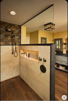 a bathroom with a walk in shower sitting next to a sink and a mirror on the wall